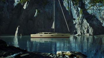 yacht blanc ancré dans une baie aux falaises rocheuses video