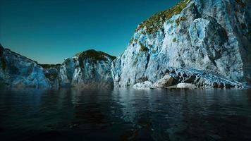 rocky cliff at cold sea water video