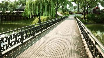 old metal bridge over a small river in park video