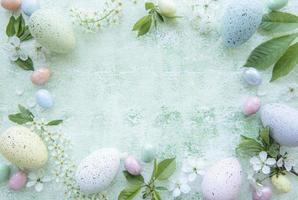 Colorful Easter eggs on green wooden background
