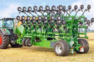 Grain seeder in transport position for compact transport of the machine as a trailed implement on a tractor. photo