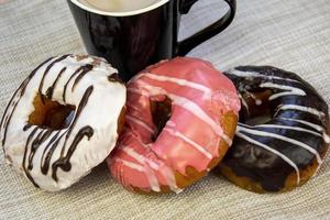 Donuts in colored glaze. Sweet pastries close-up. photo