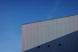 building over blue sky background photo