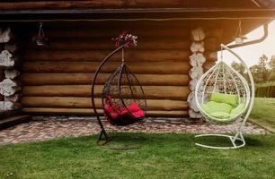 Two rattan hanging chairs photo