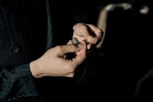 male tailor threads a needle photo