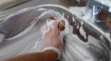 cleaning scrub steel sink with sponge photo