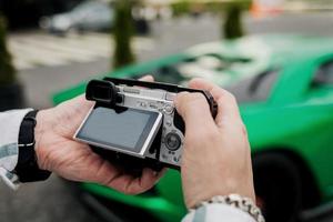 man holds a digital camera photo