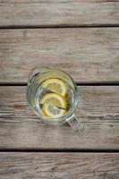 Lemonade pitcher with lemon photo