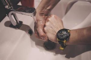 close up hands of man washing hands photo