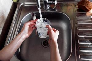 hand washing dish or pouring glass photo