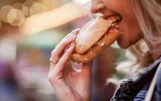 girl eats a delicious burger photo