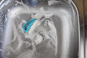 Close up sink drain and kitchen brush photo