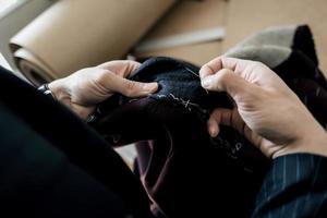 Tailor hands working in tailor shop photo