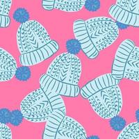 Random seamless pattern with blue cozy hat silhouettes. Pink bright background. vector