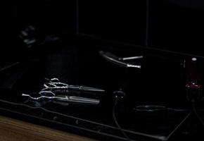 different scissors on black table photo