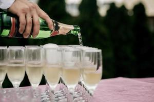 Man pours champagne photo