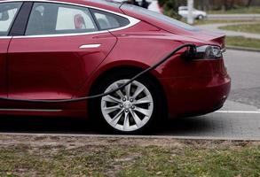 Electric car charging on parking lot photo