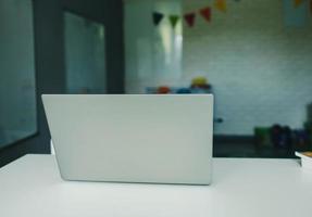 Laptop or notebook on wood table photo