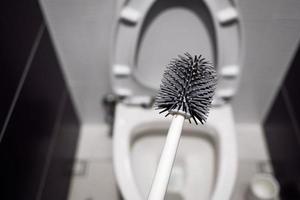 cleaning the toilet with brush photo