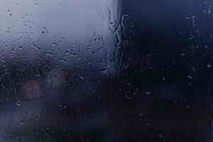 Rain drops on window's glass photo