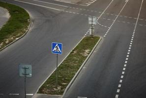 A pedestrian crossing sign over road. photo