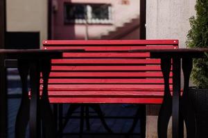 empty red cafe bench with tables photo