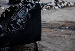 Melted trash bin in street photo