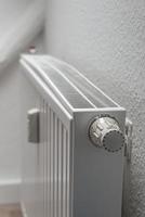 House heating battery with maximum heating power setting adjusted at its dial with copy space background. Concept of energy consumption in households. photo