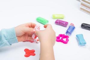 Childrens hands play dough for children's creativity. Board game for the development of fine motor skills photo