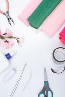 Tools and materials for creating a spring branch with sakura flowers from corrugated paper. Do it yourself photo