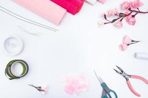 Tools and materials for creating a spring branch with sakura flowers from corrugated paper. Do it yourself. Copy space photo