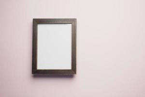 top view of empty frame on wooden background . photo