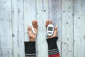 Senior women diabetic measure glucose level at home photo