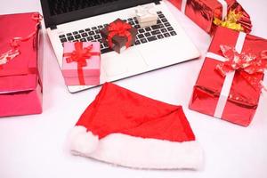 laptop and gitf box for christmas and new year celebration isolated on white background photo