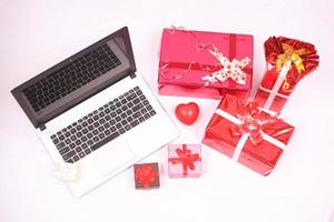 laptop and gitf box for christmas and new year celebration isolated on white background photo
