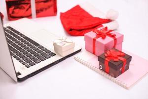 laptop and gitf box for christmas and new year celebration isolated on white background photo