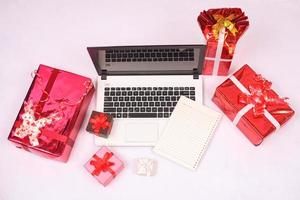 laptop and gitf box for christmas and new year celebration isolated on white background photo