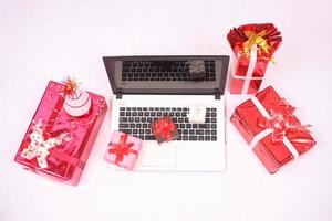 laptop and gitf box for christmas and new year celebration isolated on white background photo