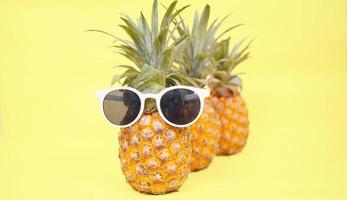 lined pineapple fruit isolated on a yellow background photo