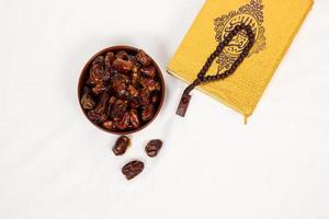 dates and quran isolated on white background