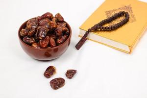 dates and quran isolated on white background photo