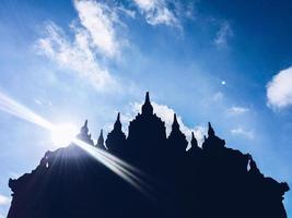 Silhouette view of Plaosan Temple in Plaosan Complex temple with blue sky and sunny sun background. One of the javanese Buddhist temples located in Prambanan, Klaten, Central Java, Indonesia. photo