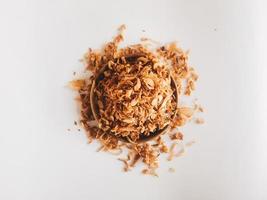 Pile of Onion fries or shallots on wood plate isolated on white background. photo