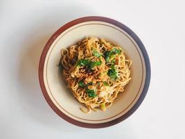 Mie Goreng Jawa or bakmi jawa or java noodle. Indonesian traditional street food noodles from central java or Yogyakarta, indonesia on white background. photo