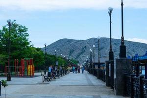 Sudak, Crimea-may 20, 2018-Urban landscape with a view of the embankment and people. photo