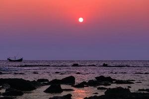 lonely boat at sunset photo