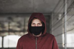 a young man in a black mask photo