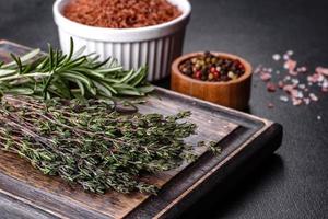 Bundle of fresh thyme grass on a wooden cutting board photo