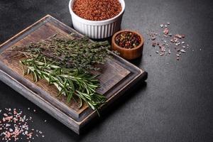 Bundle of fresh thyme grass on a wooden cutting board photo