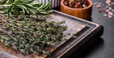 Bundle of fresh thyme grass on a wooden cutting board photo